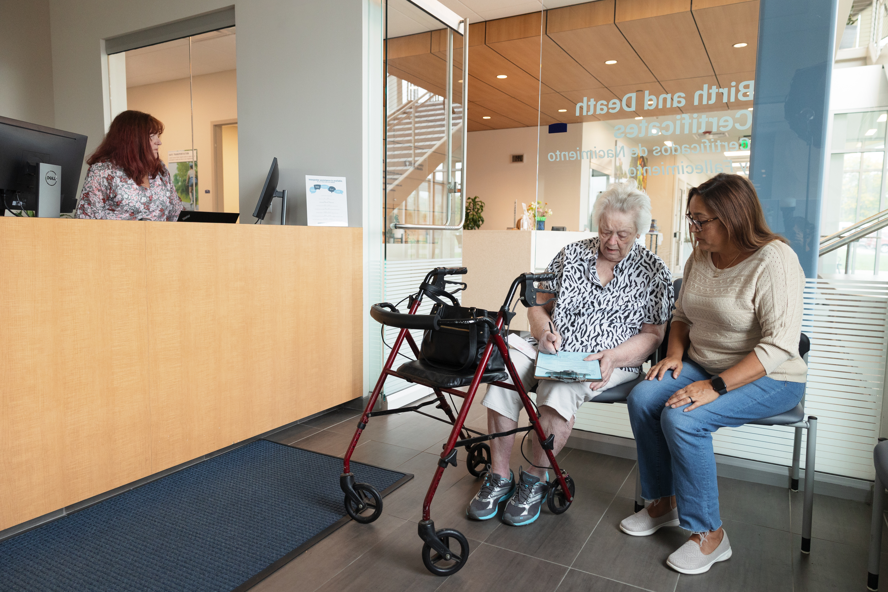 public health staff assist a client to complete paperwork