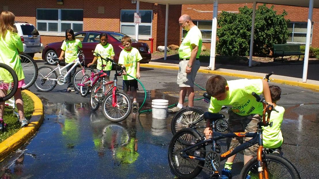 Students washing bicycles