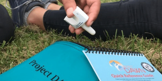 person holding Narcan rescue kit 
