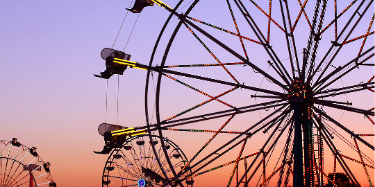 ferris wheel lights up night sky at fair 