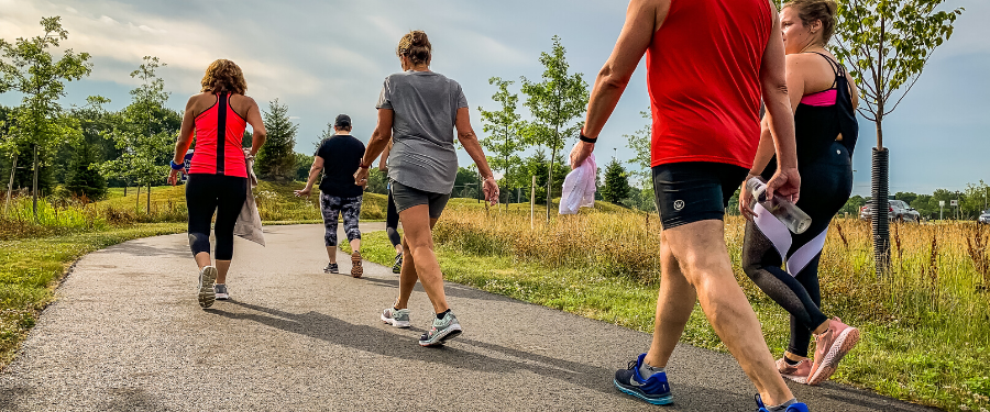 A group of fitness people walking on a park path