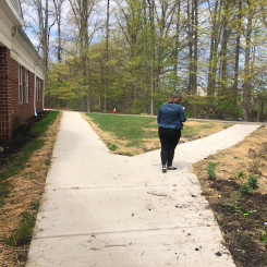 a woman walking along a two-pronged sidewalk