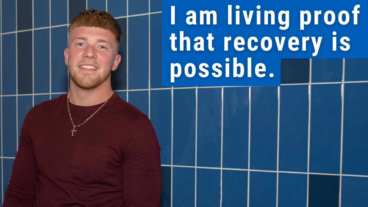 man standing and smiling with text "I am living proof recovery is possible" 