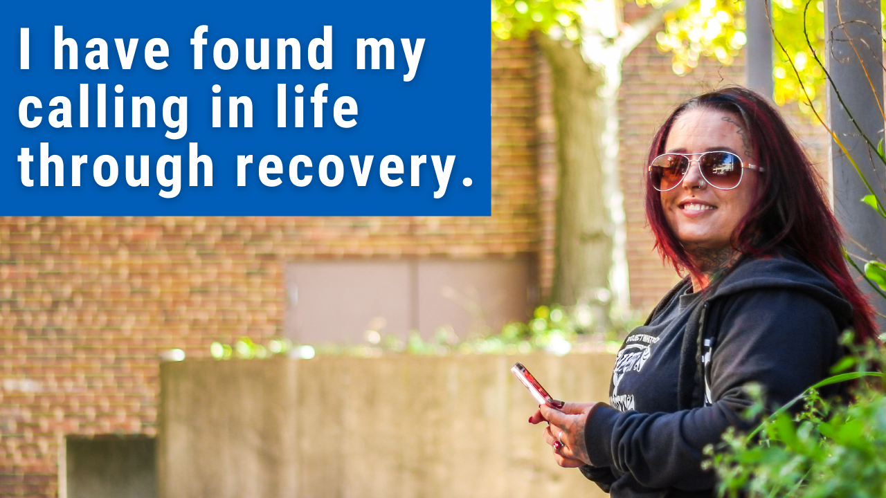 woman standing with text "i am living proof recovery is possible"