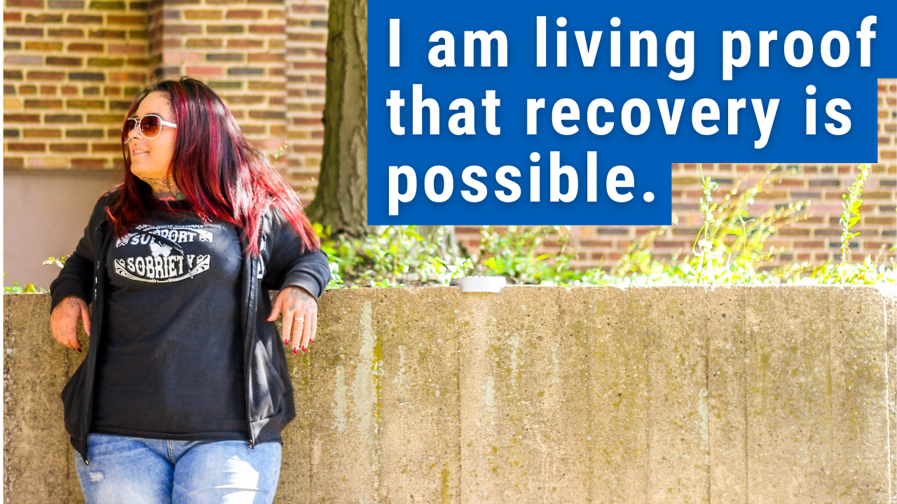 woman standing with text "i am living proof recovery is possible"