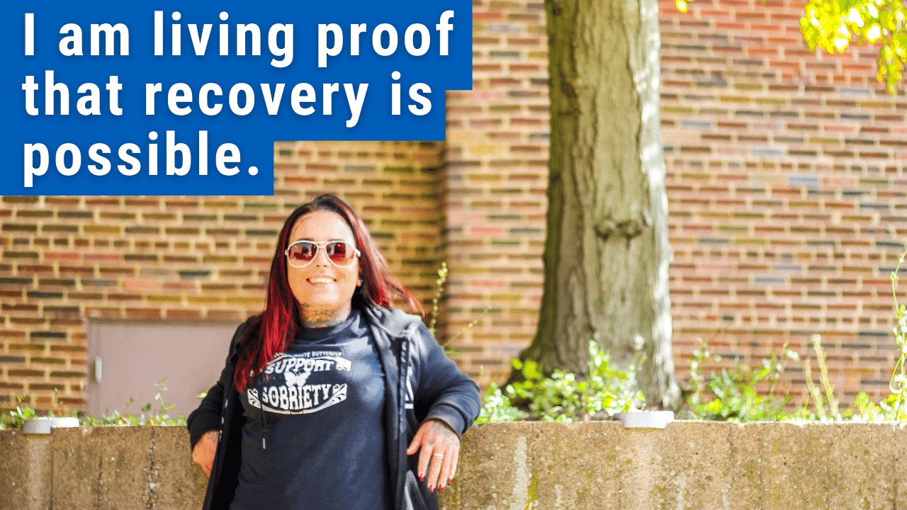 woman standing with text "i am living proof recovery is possible"