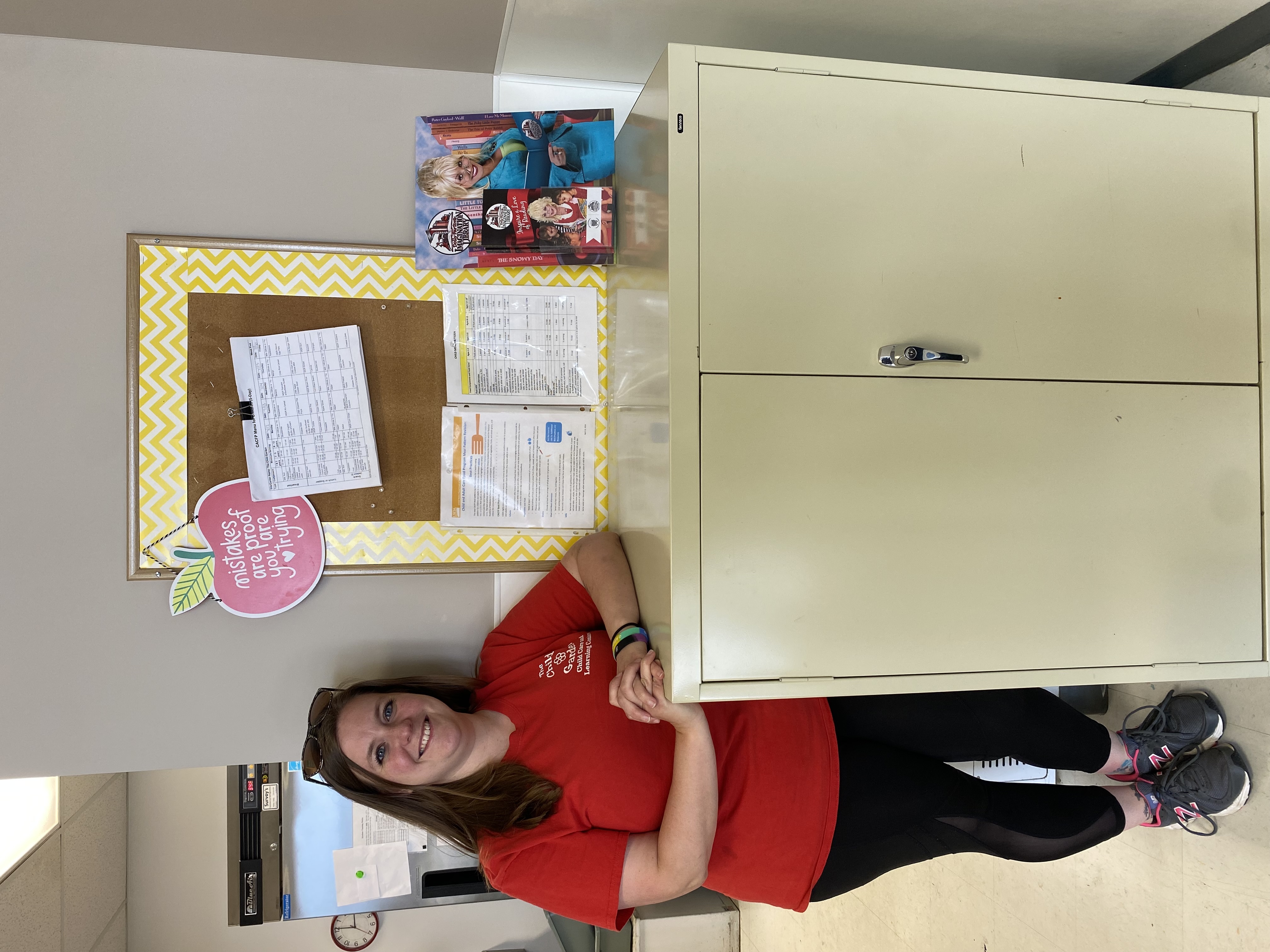 childcare director standing with ohio healthy programs designation sign 