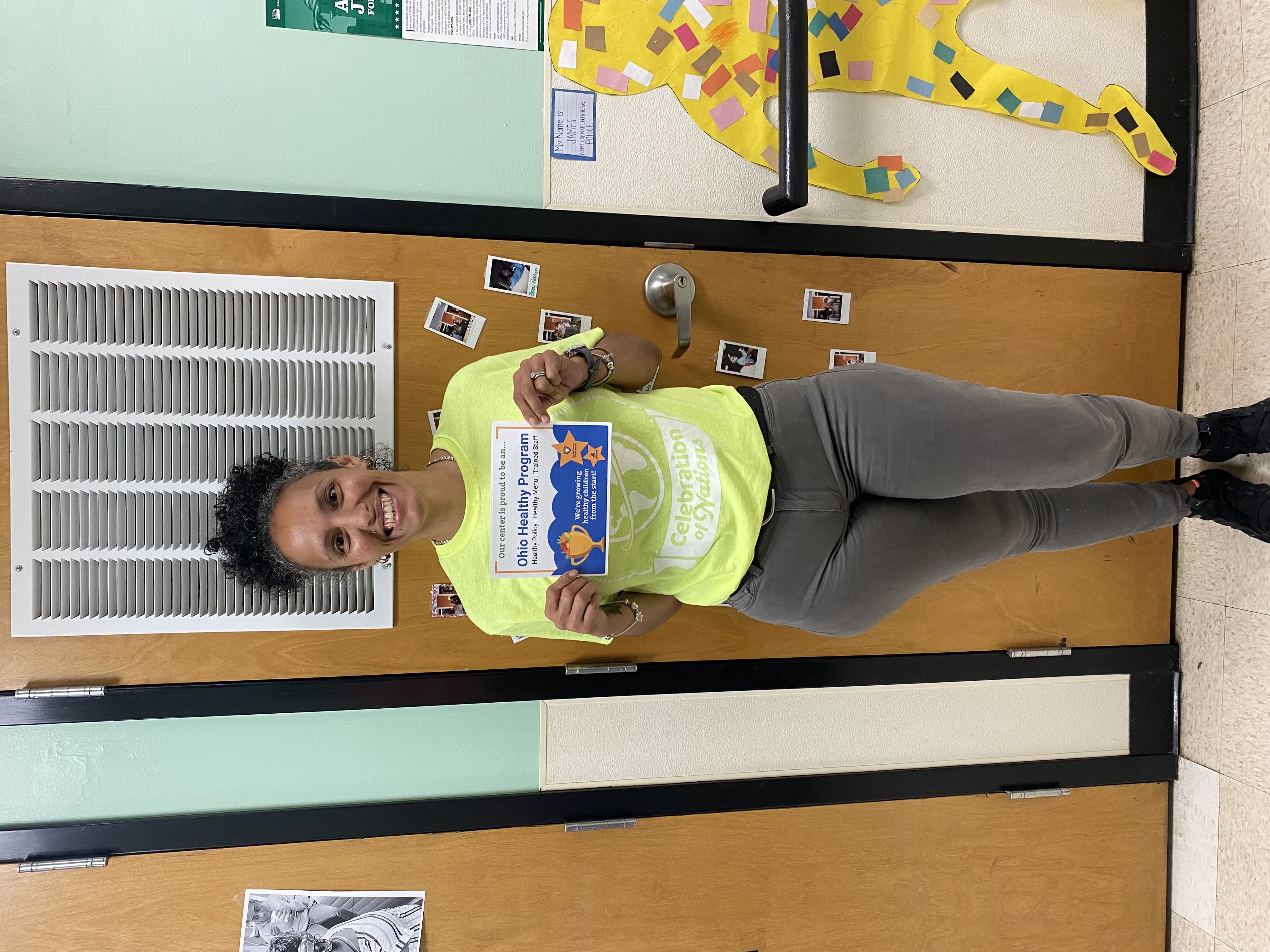 childcare director standing with ohio healthy programs designation sign 