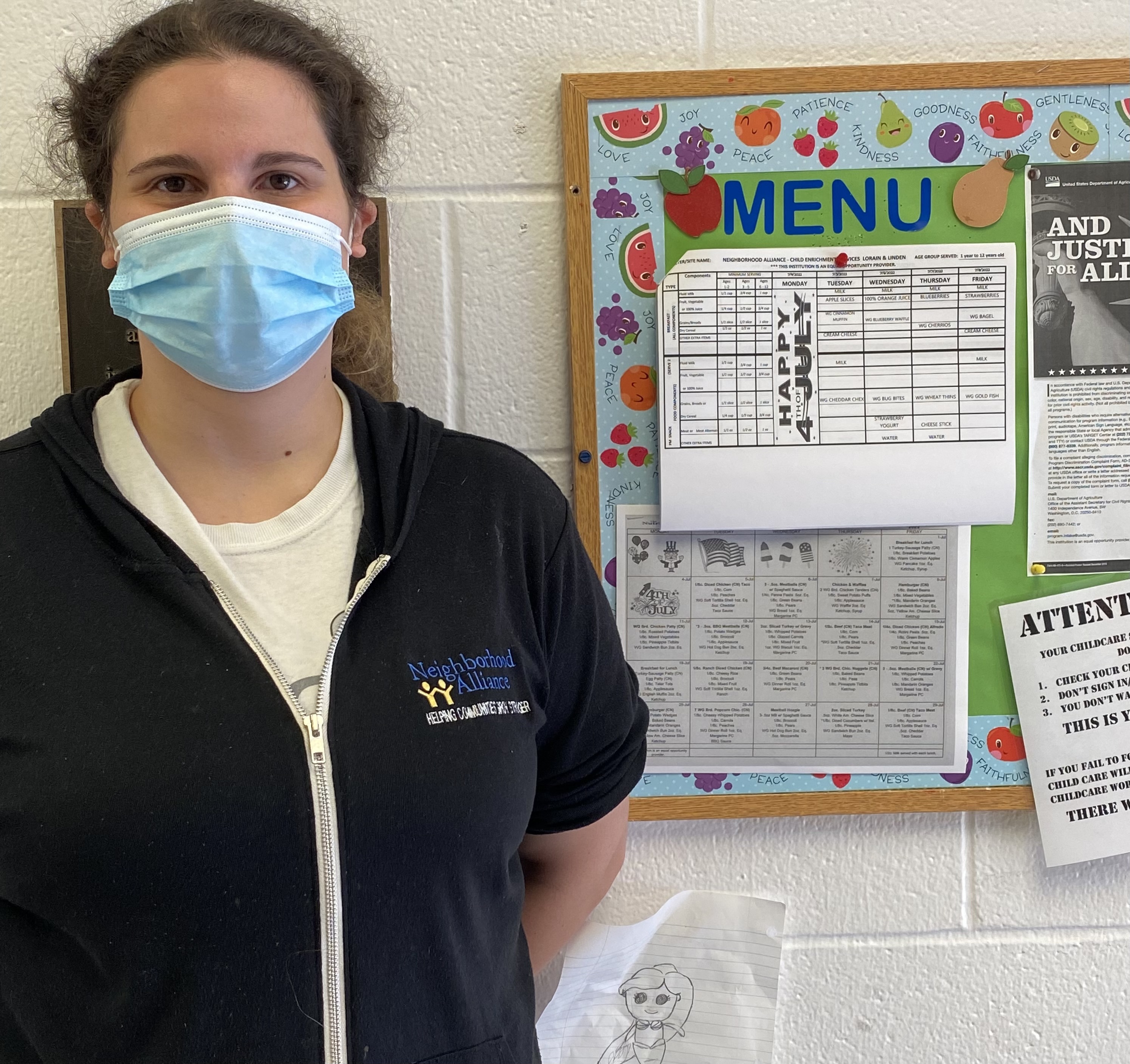 childcare director standing with ohio healthy programs designation sign 