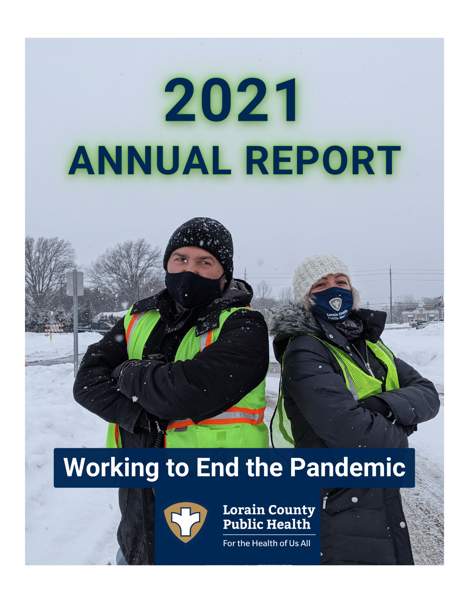 title: 2021 Annual Report: working to end the pandemic. Photo: two LCPH employees in hi-viz vests in the snow during a vaccine clinic